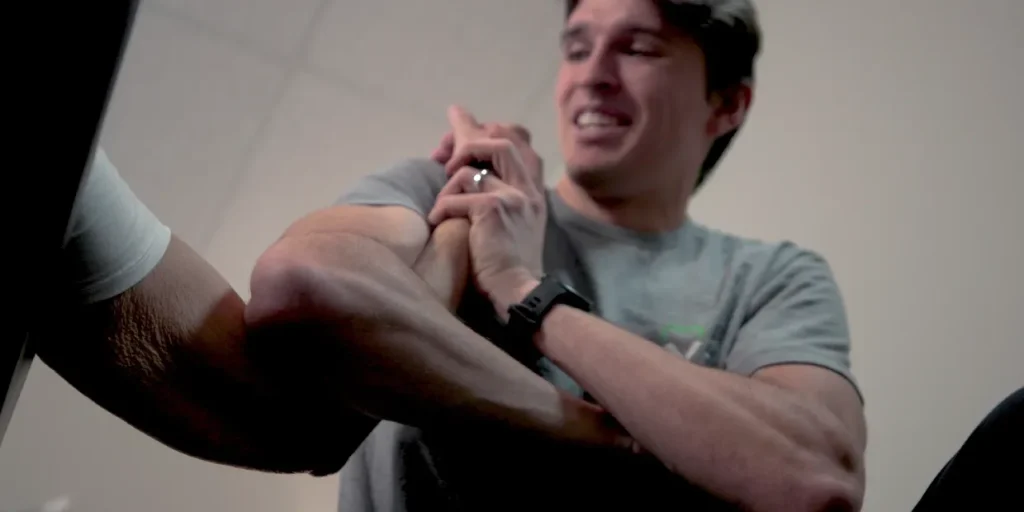 Kinesiologist performing fascial stretch therapy on a client.